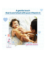Johnson's baby oil bottle and smiling baby with "gentle touch" Vitamin E text