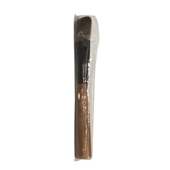 Facial mask brush with dark bristles, in clear plastic sleeve
