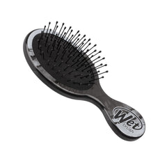 Wet hair detangling brush with black bristle cushion and oval grip handle