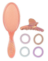 Peach holographic detangling hair brush with round bristle head and four hair coils