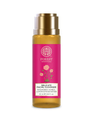 Delicate facial cleanser bottle with gold cap, amber body, and pink front label.