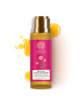 Facial cleanser bottle with gold cap, amber body, and pink label.