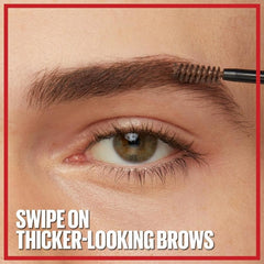 Eyebrow styling gel applied with spoolie brush on brown eyebrows