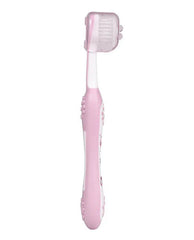 Pink and white toothbrush with protective cap and bee print on handle