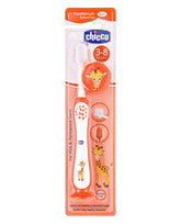Orange toothbrush with soft bristles and giraffe print, shown in retail package