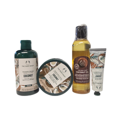 Coconut body care gift set with shower cream, oil bottle, cream tube, and jar