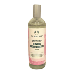 Body mist bottle with gold cap, clear liquid, pink label for Glowing Cherry Blossom