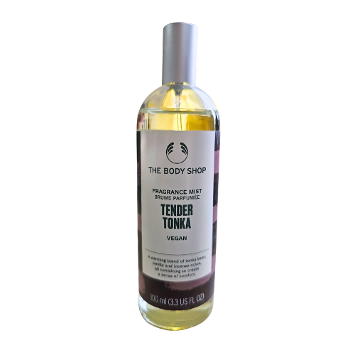 Fragrance body mist bottle with silver cap; yellow liquid; The Body Shop Tender Tonka