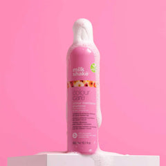 Pink colour care shampoo bottle, front view, pump top