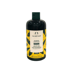 Banana shampoo bottle with dark green cap, vegan yellow label
