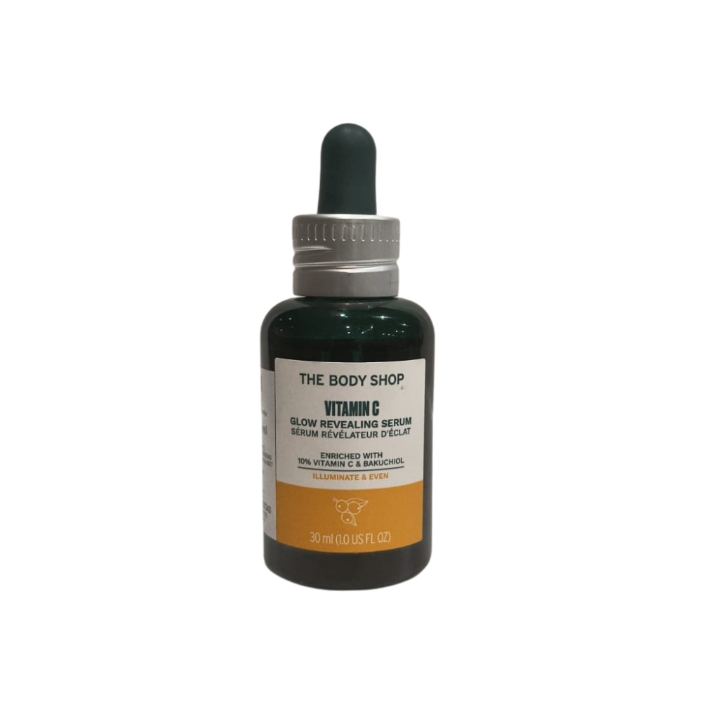 The Body Shop Vitamin C glow serum in dark green glass bottle with dropper