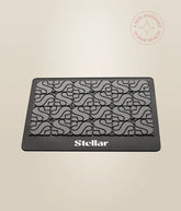 Stellar heat mat in black with repeating stylized S pattern and Stellar logo