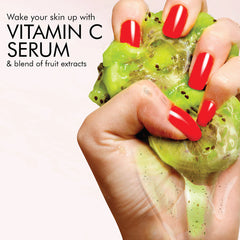 Green kiwi gel cleanser on hands over a kiwi fruit
