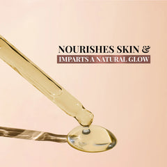 Facial oil on a dropper tip, showing glossy golden oil strand.