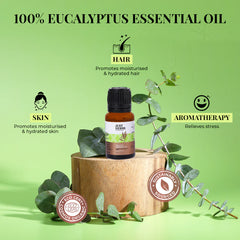 Eucalyptus essential oil bottle on wooden block with eucalyptus leaves and oil drops