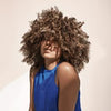 Deep repair hair treatment mask shown with curly hair and sleeveless blue top