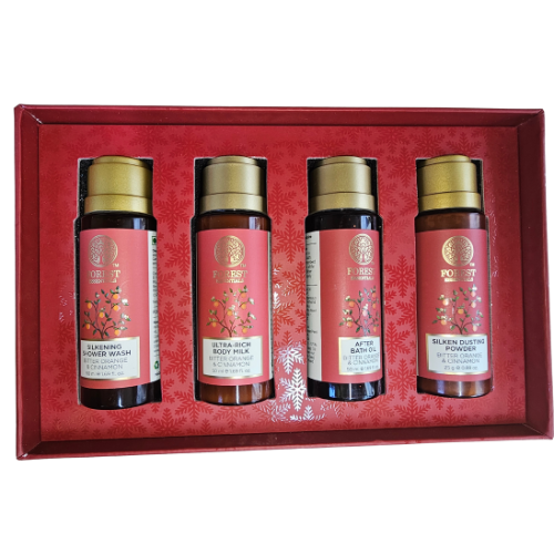Forest Essentials gift set bottles in red box, with four dark amber and gold-capped containers