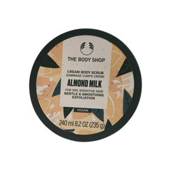 The Body Shop almond milk body scrub jar lid, cream body scrub text and vegan label