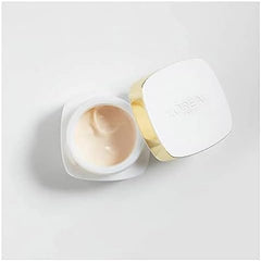 Night cream jar open, showing beige cream and white cap