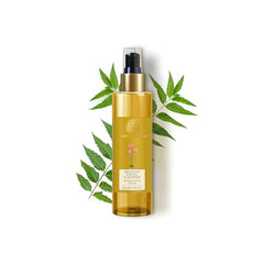 Delicate facial cleanser bottle with gold pump and green neem leaves
