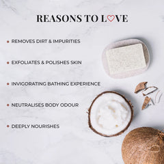 Speckled off-white bath bar with a coconut half beside it, close-up view.