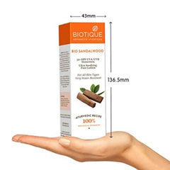 Biotique Bio Sandalwood SPF 50+ face lotion bottle and box held in hand