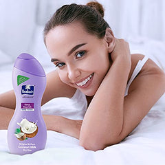 Parachute Advansed Deep Nourish body lotion beside smiling woman on bed