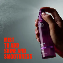 Wella purple spray bottle held in hand, cylindrical canister with nozzle, 95 ml