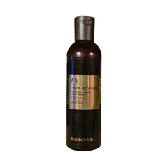 The Body Shop body wash bottle, dark brown with flip-top cap and front label