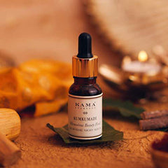 Kama Ayurveda Kumkumadi night serum bottle with dropper on a stone-like surface