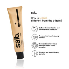 Beige-gold salt toothpaste tube with black cap, shown at an angle.