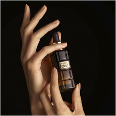 Midnight serum bottle held in hand with dark dropper