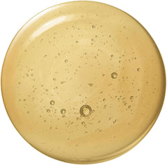 Golden serum sample in circular dish with small bubbles