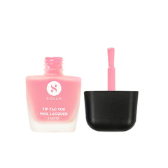 Matte nail lacquer bottle with open brush, pink flamingo shade, black base