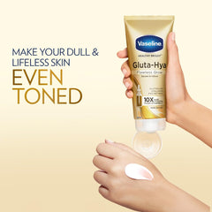 Vaseline Gluta-Hya serum-in-lotion tube in a hand, with glossy lotion smear