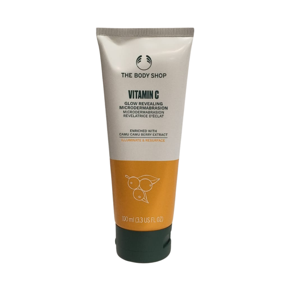 Facial microdermabrasion cream in a cream-and-orange squeeze tube, dark cap