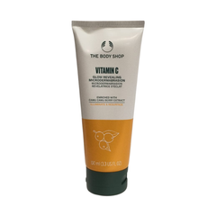 Facial microdermabrasion cream in a cream-and-orange squeeze tube, dark cap