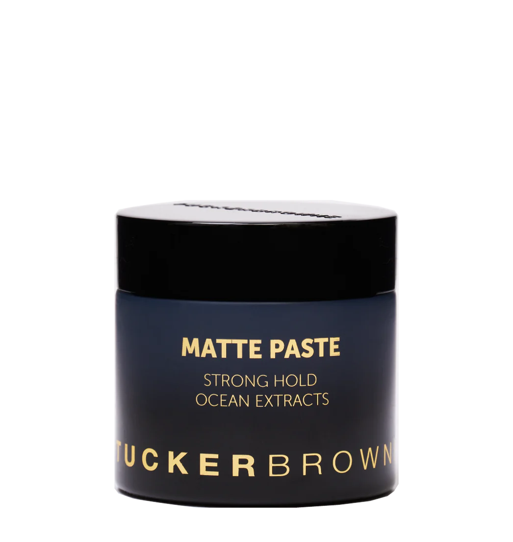 Matte paste hair styling jar with black lid and blue label