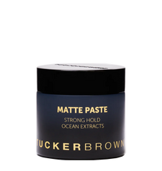 Matte paste hair styling jar with black lid and blue label