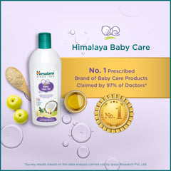 Himalaya Baby Hair Oil bottle with gold No. 1 badge and herb graphics.