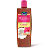 Bhringraj & Hibiscus hair oil bottle with pink cap, brown label
