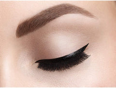 Black winged eyeliner with full lashes on closed eye