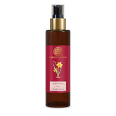 Forest Essentials body mist bottle, amber glass with red label and gold pump