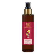 Forest Essentials body mist bottle, amber glass with red label and gold pump