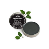 Green infused post-wash hair balm tin with dark balm and leaf sprigs