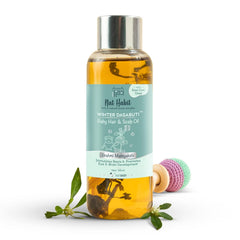 Baby hair and scalp oil bottle with amber liquid and metal cap