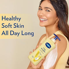 Vaseline deep moisture body lotion bottle, yellow formula, held for application