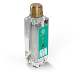 Coconut virgin oil bottle with gold cap and teal label, clear glass