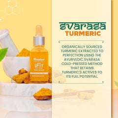 Turmeric face serum bottle with turmeric powder, herb, and cream jar on counter.