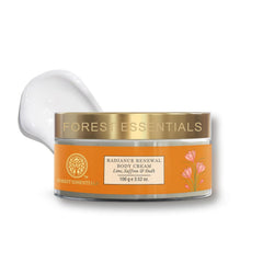 Body cream jar with gold lid and orange label, white cream scoop behind